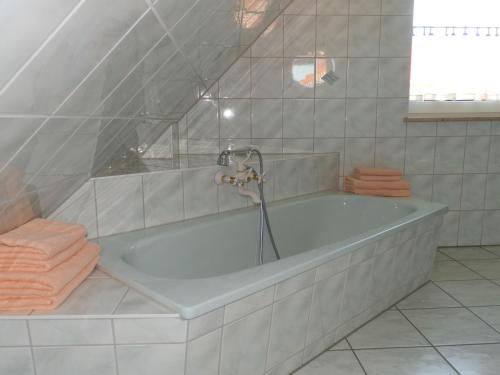 a bath tub with a faucet in a bathroom at Twee Linden Nienhagen in Ostseebad Nienhagen