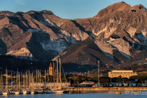 a large body of water with mountains at Hotel Morgana in Marina di Carrara