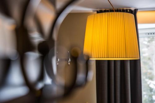 a yellow lamp in a room with a window at Hotell Fjällgården Ski-In Ski-Out in Åre