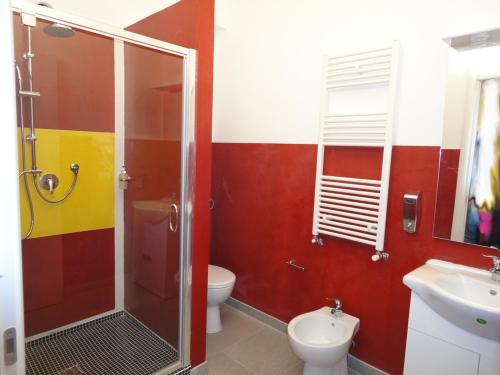 a bathroom with a shower and a toilet and a sink at Pavia Ostello in Pavia