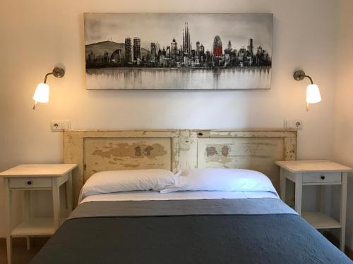 a bedroom with a bed with two nightstands and a painting at Hostal Portugal in Barcelona