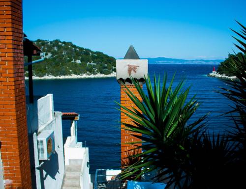 a building with a view of a body of water at Guesthouse Santor in Lastovo