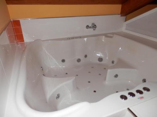 a white bath tub in a bathroom at Apartamentos Monte Hernanz in Riaza
