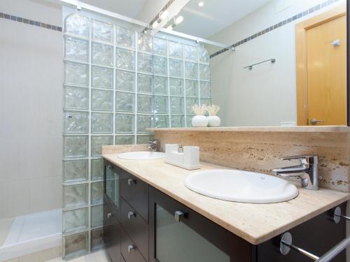 a bathroom with two sinks and a shower at RentBCN Rambla Catalunya Apartment in Barcelona