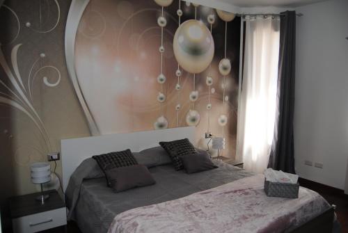 a bedroom with a bed with balloons on the wall at B&B Kenzia in Olbia
