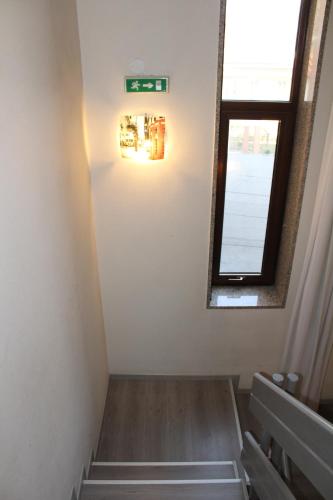 a room with stairs and a window and a mirror at Alla Bianca Hotel in Marghera