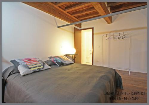 a bedroom with a bed with two pillows on it at Appartamento Il Fregio in Pistoia