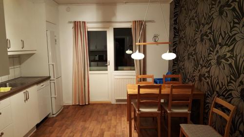 uma cozinha e sala de jantar com mesa e cadeiras em Borggården Apartment em Hultsfred