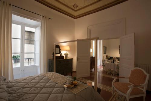 パレルモにあるCasa degli Alloriのベッドルーム1室(ベッド1台、大きな窓付)
