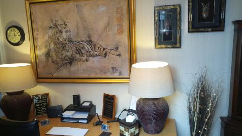 a desk with two lamps and a telephone on it at Warwick Lodge in Carlisle