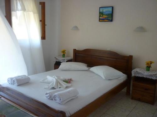 a bedroom with a bed with towels on it at Voula Pansion in Kardamili