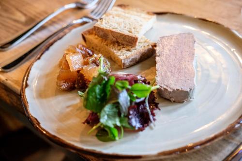 a plate of food with bread and salad on it at The White Hart in Stockbridge