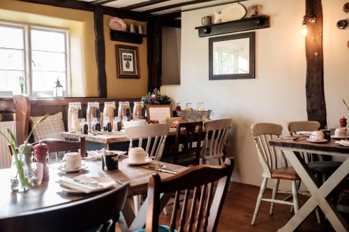 a dining room with tables and chairs and a window at The White Hart in Stockbridge
