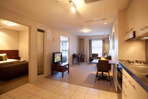 a room with a kitchen and a living room at VR Auckland City in Auckland