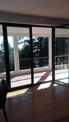 a room with a view of a balcony with sliding glass doors at Casa dos Arcos in Caramulo