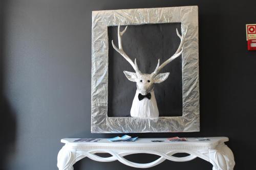 a picture of a deer wearing a bow tie at Hotel Muchacho in Macedo de Cavaleiros