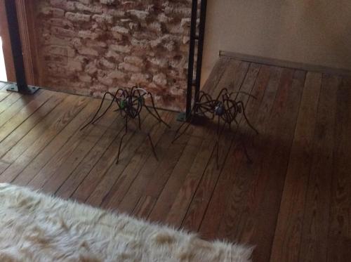 a room with a wooden floor and a brick wall at Las Glicinas Boutique Apartments in Colonia del Sacramento