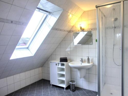 a bathroom with a sink and a skylight at Villa Hermes in Hagen