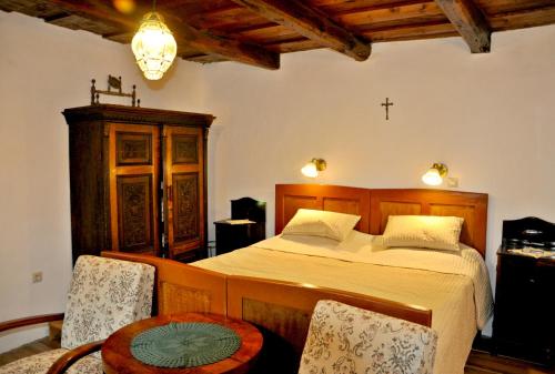 um quarto com uma cama e uma cruz na parede em Nefelejcs Vendégház Hollókő em Hollókő