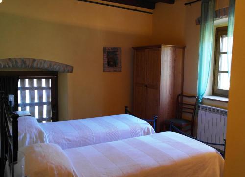 a bedroom with two beds and a window at B&B Ai Chiosi in Pontremoli