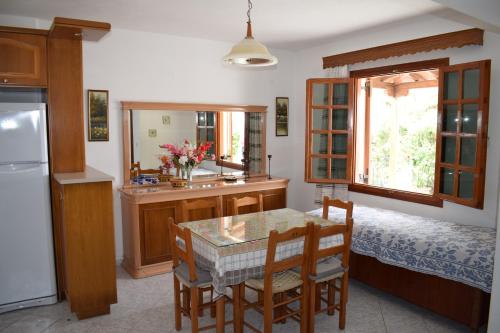 a kitchen with a table and chairs and a sink at Evagelia's Houses in Votsi