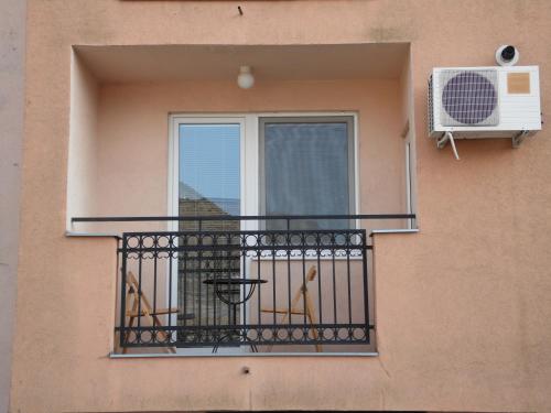 a balcony of a building with a window at Apartment Atina in Subotica