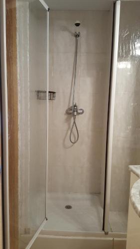 a shower with a glass door in a bathroom at Enginyapartaments in Figueres