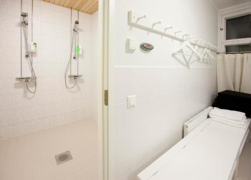 a bathroom with a shower with a bench in it at Ahlströmin Ruukki Noormarkku in Pori