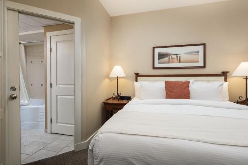 a hotel room with a bed and a bathroom at Summerland Waterfront Resort & Spa in Summerland