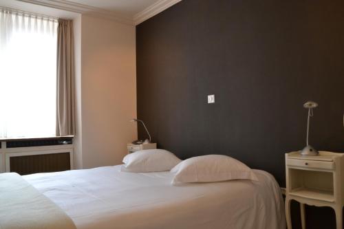 Ένα ή περισσότερα κρεβάτια σε δωμάτιο στο Hostellerie au Cygne