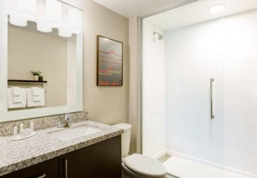 a bathroom with a toilet and a sink and a shower at TownePlace Suites by MarriottDetroit Canton in Canton