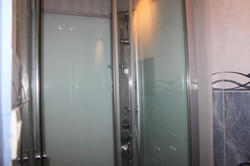 ブールゴアンにあるLe Panoramaのバスルーム(ガラスドア付きのシャワー付)