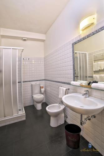 a bathroom with a sink and a toilet and a shower at Hotel Italia in Lerici