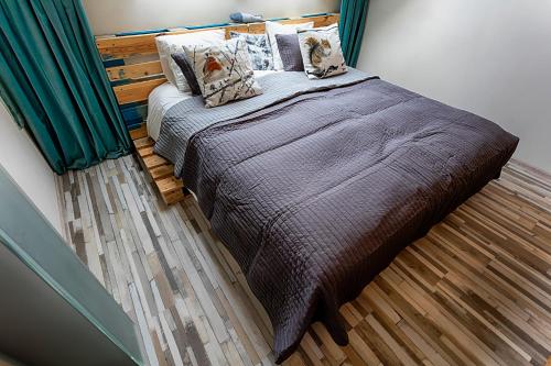 a bedroom with a bed with a brown blanket and pillows at Chateau Nightingales in Hostouň