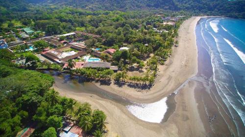 an aerial view of a beach next to the ocean at Beach Break Resort & CR Surf Camp in Jacó