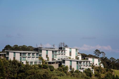 a row of apartment buildings on a hill at Doubtless Bay Villas in Cable Bay