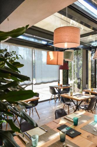 a restaurant with tables and chairs and a large window at Locanda Ristorante da Umberto in Malo
