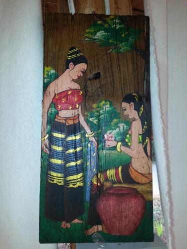 a painting of a man and a woman on a wall at Tulip Resort Pai in Pai