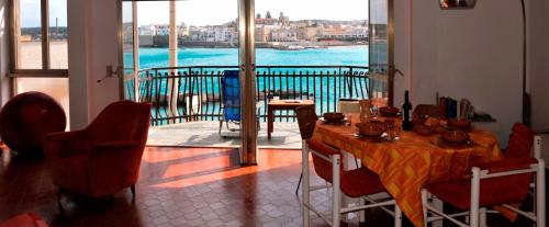 a dining room with a table and a view of the water at Otranto in riva al mare in Otranto