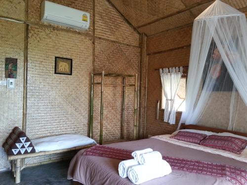 a room with two beds with towels on them at Tulip Resort Pai in Pai