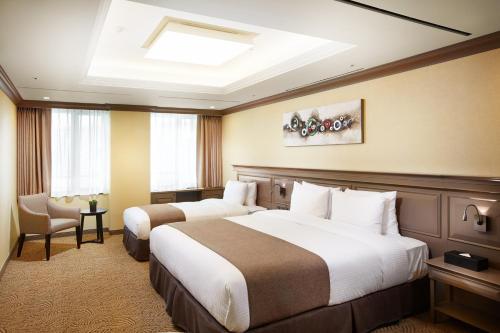 Un pat sau paturi într-o cameră la Hotel Prumir