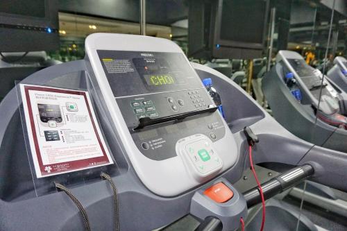 a cell phone on a machine with a charger at Kew Green Hotel Wanchai Hong Kong in Hong Kong
