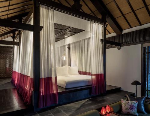 A bed or beds in a room at Four Seasons The Nam Hai, Hoi An, Vietnam