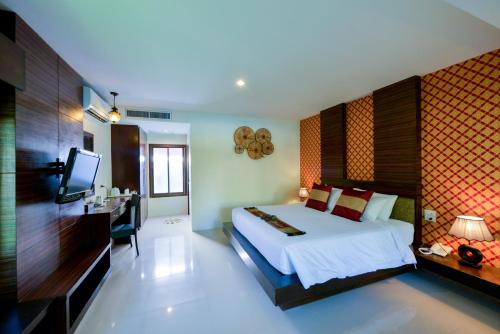 a bedroom with a bed and a television in it at Sita Beach Resort in Ko Lipe