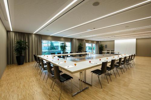 a large conference room with a long table and chairs at Montfort - das Hotel in Feldkirch
