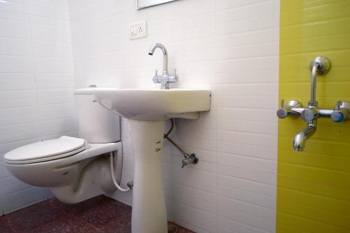 a bathroom with a sink and a toilet at Rising Sun Retreat in Mount Ābu