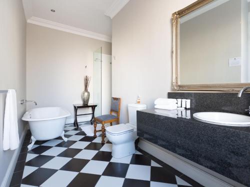 a bathroom with a toilet, sink and bathtub at Long Street Boutique Hotel in Cape Town