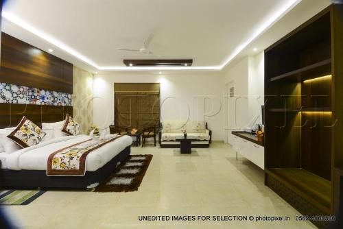 a bedroom with a large bed and a bathroom at Palm Galaxy in Itimādpur