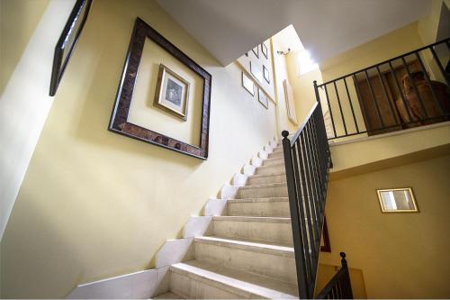 a stairway with a picture hanging on the wall at S.Andrea degli Armeni Dimora di Charme in Taranto
