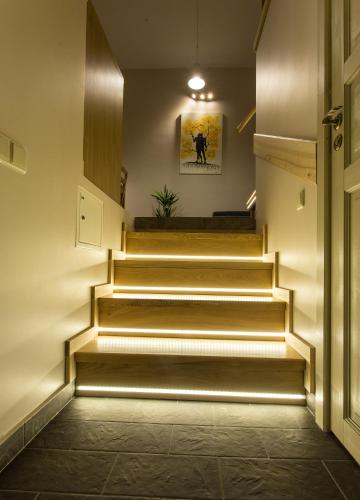 a hallway with stairs in a building with a light at Inga Vacation House in Druskininkai